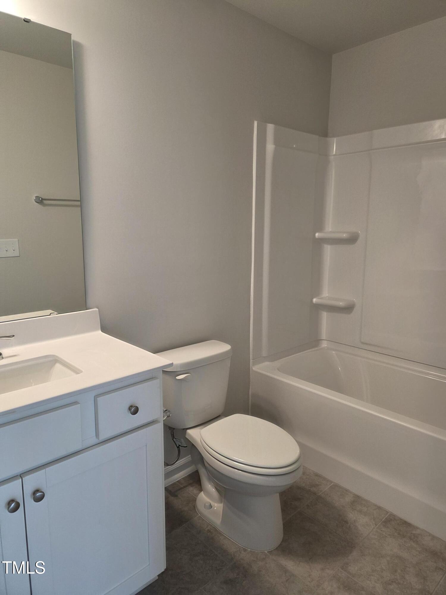 176 Paramount Drive Smithfield, NC 27577 - Photo 15 of 22 a bathroom with a toilet a sink and bathtub