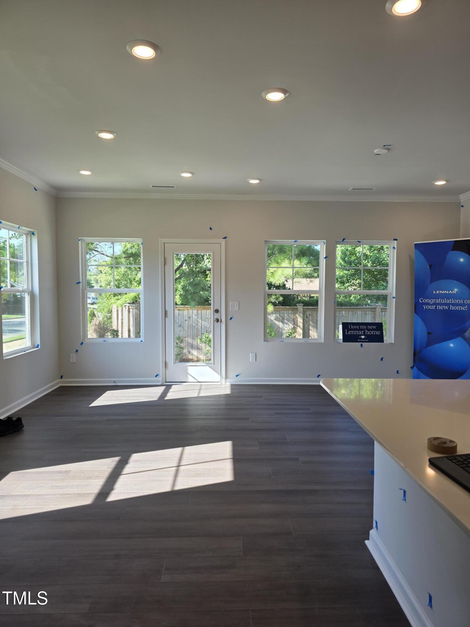 176 Paramount Drive Smithfield, NC 27577 - Photo 3 of 22 an empty room with wooden floor and windows