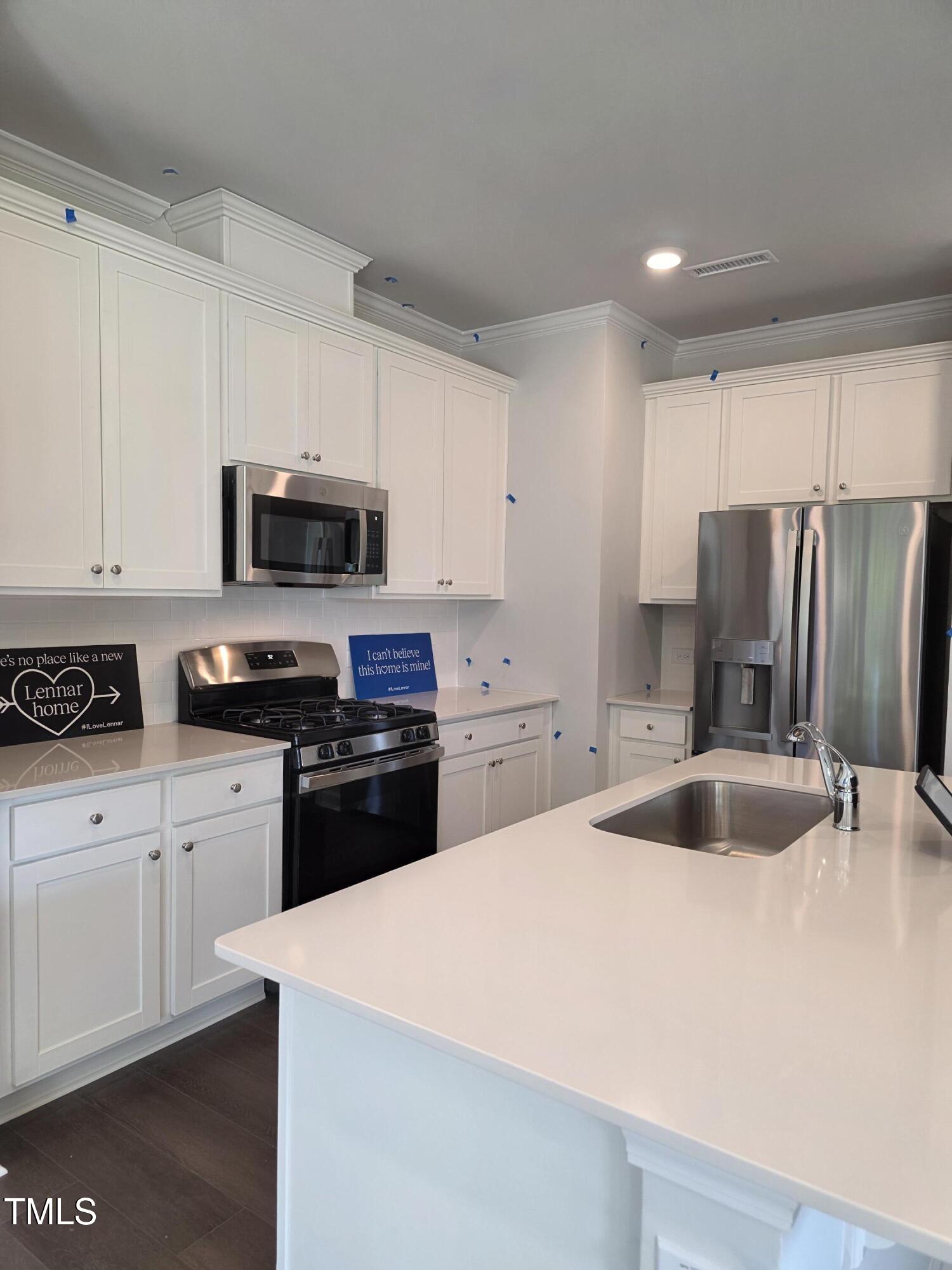 176 Paramount Drive Smithfield, NC 27577 - Photo 8 of 22 a kitchen with kitchen island a sink appliances and cabinets