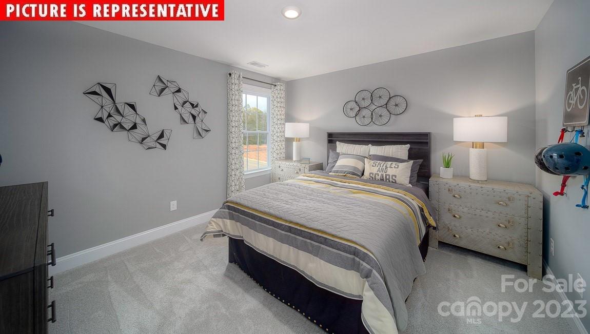 309 Streamwood Road Troutman, NC 28166 - Photo 33 of 47 a bedroom with a bed and a painting on the wall