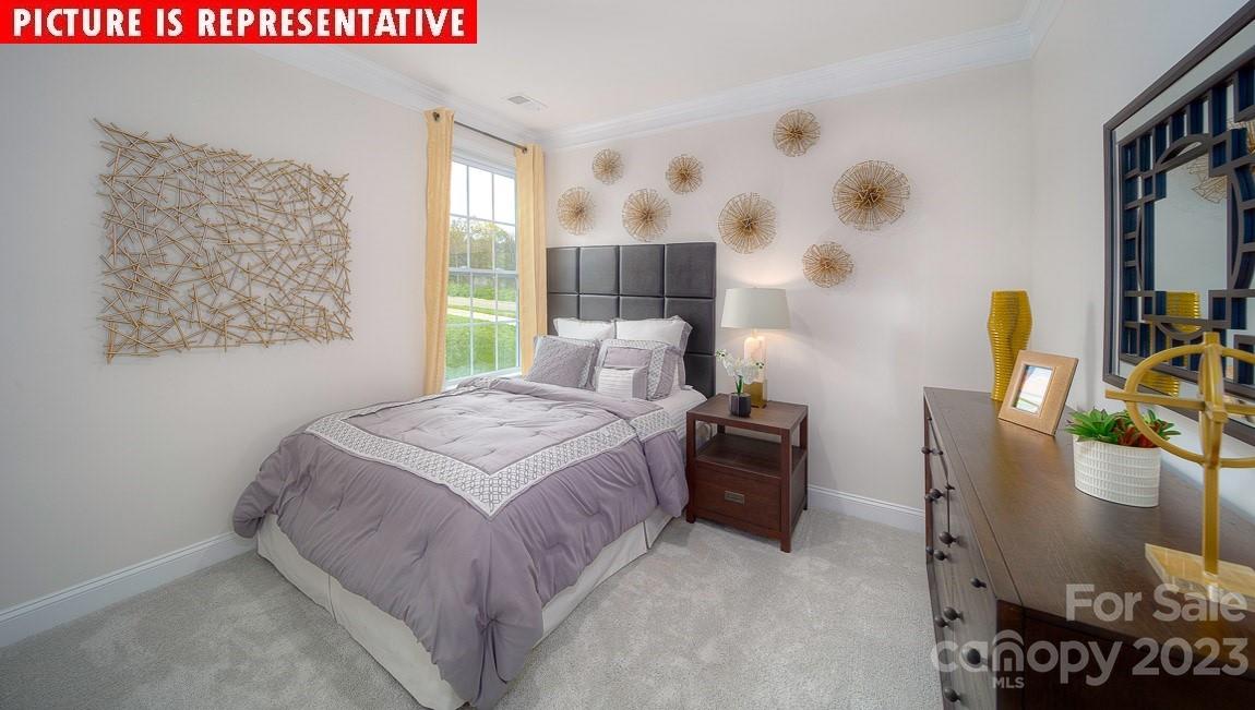 309 Streamwood Road Troutman, NC 28166 - Photo 34 of 47 a bedroom with a bed and a painting on the wall