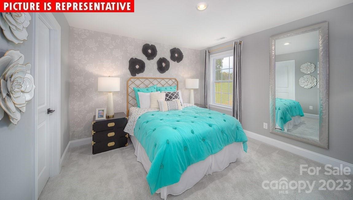 309 Streamwood Road Troutman, NC 28166 - Photo 35 of 47 a bed room with a bed and a painting on the wall