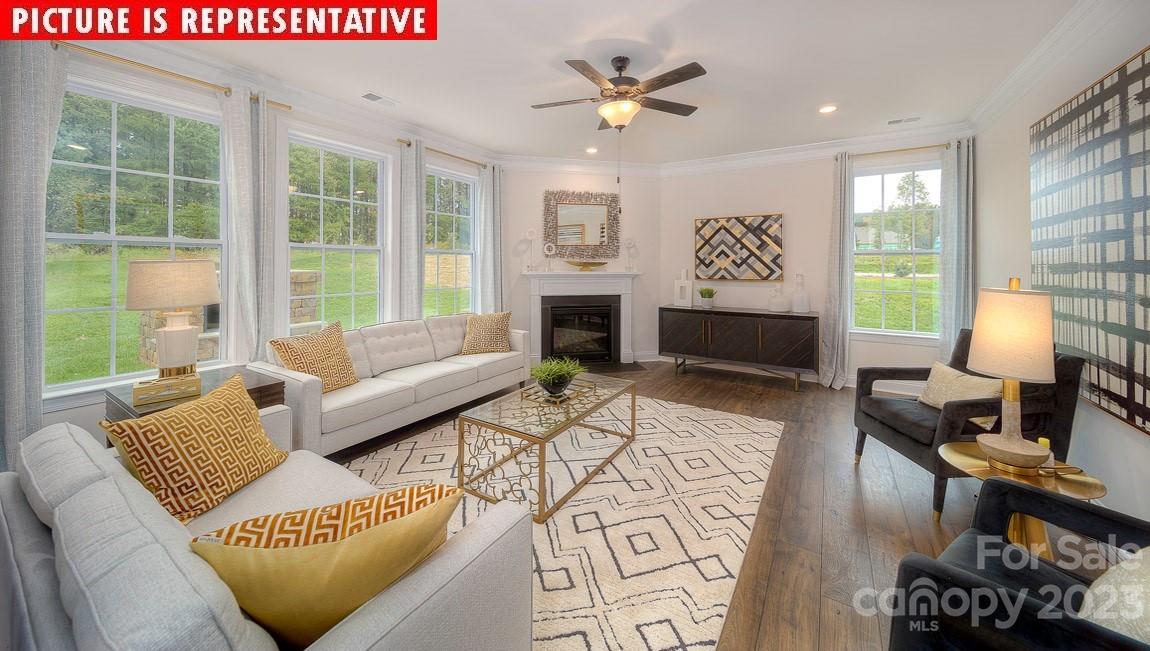 309 Streamwood Road Troutman, NC 28166 - Photo 6 of 47 a living room with furniture fireplace and window