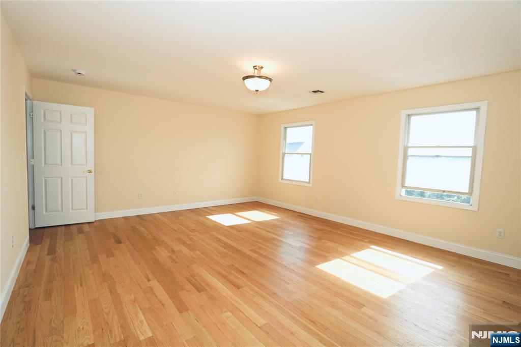 23 Main Avenue Wallington, NJ 07057 - Photo 22 of 29 a view of empty room with wooden floor and fan