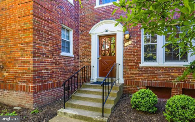 1742 North Rhodes Street, Unit 5304 Arlington, VA 22201 - Photo 3 of 11 a front view of a house with a yard