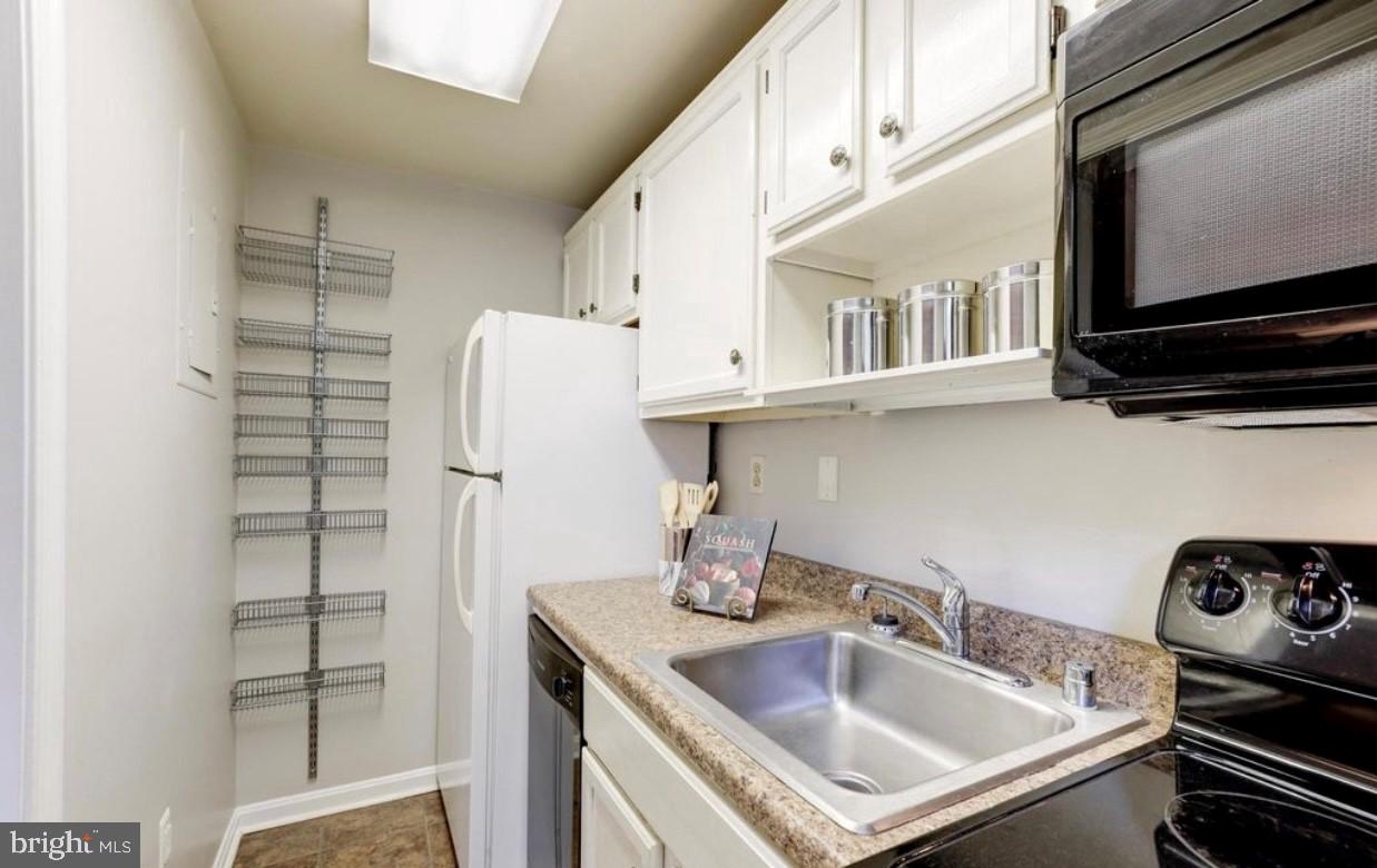 1742 North Rhodes Street, Unit 5304 Arlington, VA 22201 - Photo 7 of 11 a kitchen with stainless steel appliances granite countertop a sink and a refrigerator