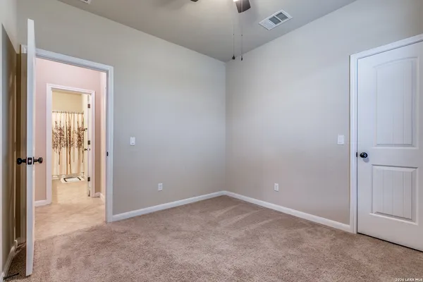 a view of an empty room and closet area