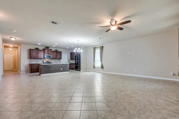 a view of kitchen and kitchen with stainless steel appliances granite countertop cabinets