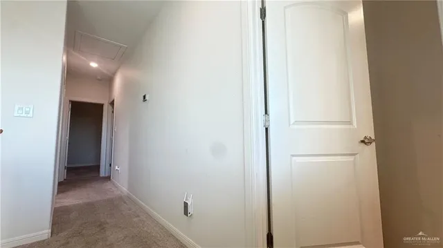 a bedroom with a bed and a flat tv screen on dresser