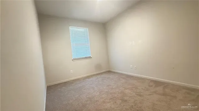 an empty room with a ceiling fan and a window