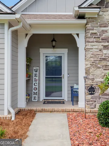 a view of a hallway with wooden floor and a chandelier