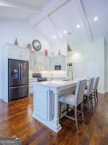 a bathroom with a granite countertop sink mirror and shower