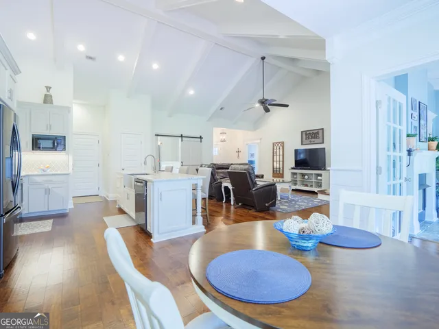 a bathroom with a granite countertop shower a sink and a mirror