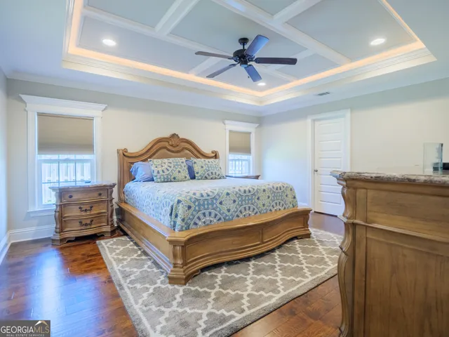 a bathroom with a granite countertop toilet sink and mirror