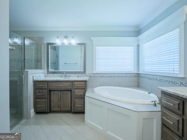 a bathroom with a granite countertop sink double and mirror