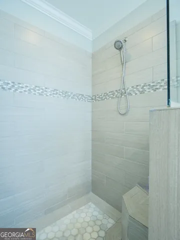 a spacious bedroom with a bed and a chandelier