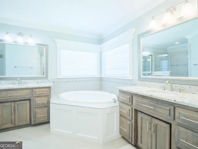a bathroom with a granite countertop sink a toilet and a mirror