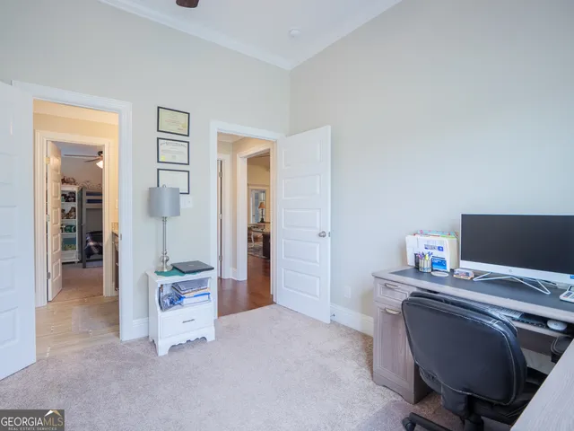 a front view of a house with a yard and trees