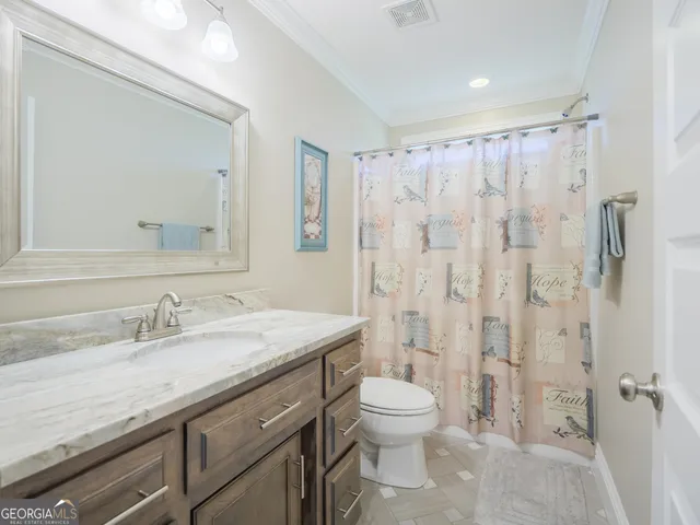 a front view of a house with yard and parking