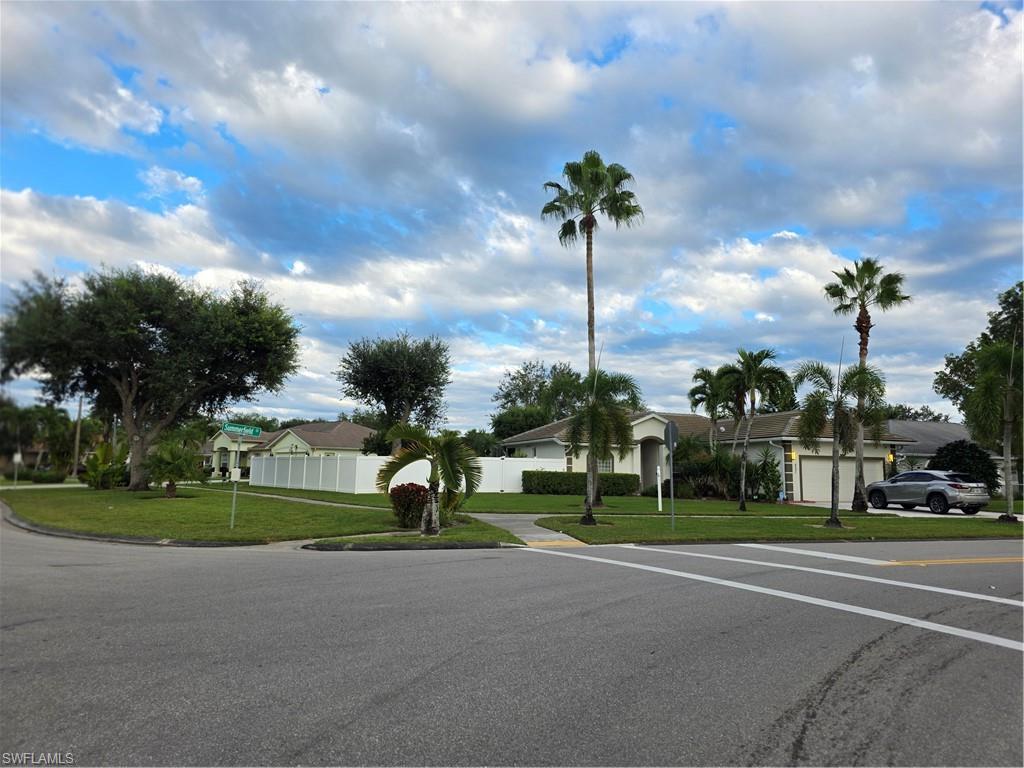 857 Summerfield Drive Naples, FL 34120 - Photo 1 of 50 a green field with lots of trees in the background