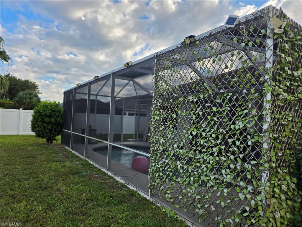 857 Summerfield Drive Naples, FL 34120 - Photo 13 of 50 a backyard of a house with lots of green space and plants