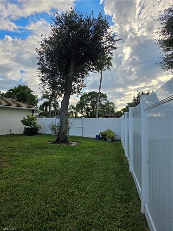 857 Summerfield Drive Naples, FL 34120 - Photo 16 of 50 a view of a backyard with large tree