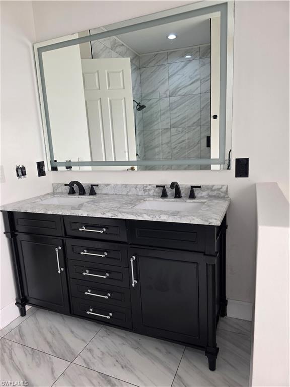 857 Summerfield Drive Naples, FL 34120 - Photo 29 of 50 a bathroom with a granite countertop sink and a mirror
