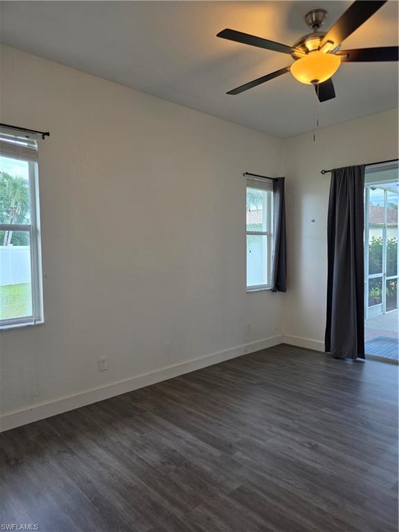 857 Summerfield Drive Naples, FL 34120 - Photo 30 of 50 a view of an empty room with window and wooden floor