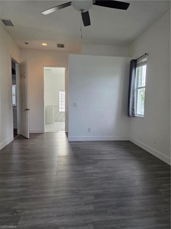 857 Summerfield Drive Naples, FL 34120 - Photo 31 of 50 an empty room with wooden floor and windows