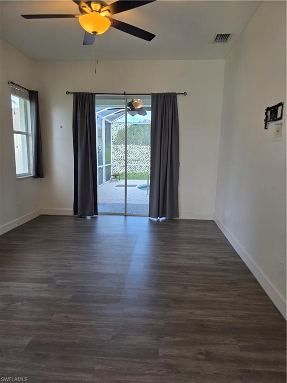 857 Summerfield Drive Naples, FL 34120 - Photo 34 of 50 a view of an empty room with wooden floor and a window