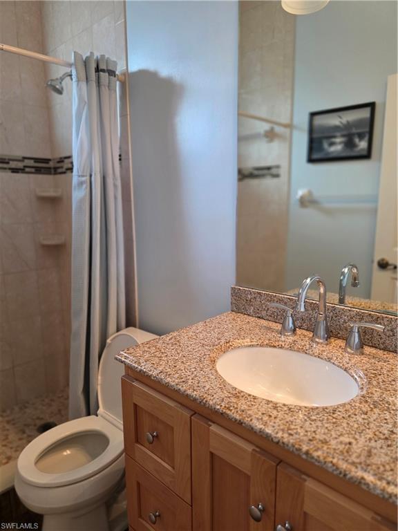 857 Summerfield Drive Naples, FL 34120 - Photo 41 of 50 a bathroom with a granite countertop sink toilet and shower