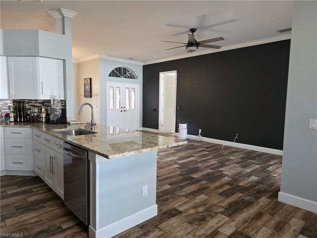857 Summerfield Drive Naples, FL 34120 - Photo 43 of 50 a kitchen with a sink stove and cabinets
