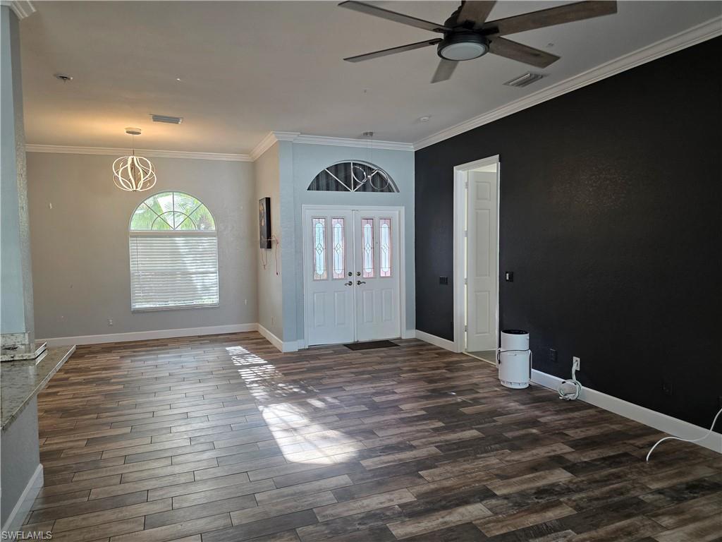 857 Summerfield Drive Naples, FL 34120 - Photo 47 of 50 a view of an empty room with window and wooden floor