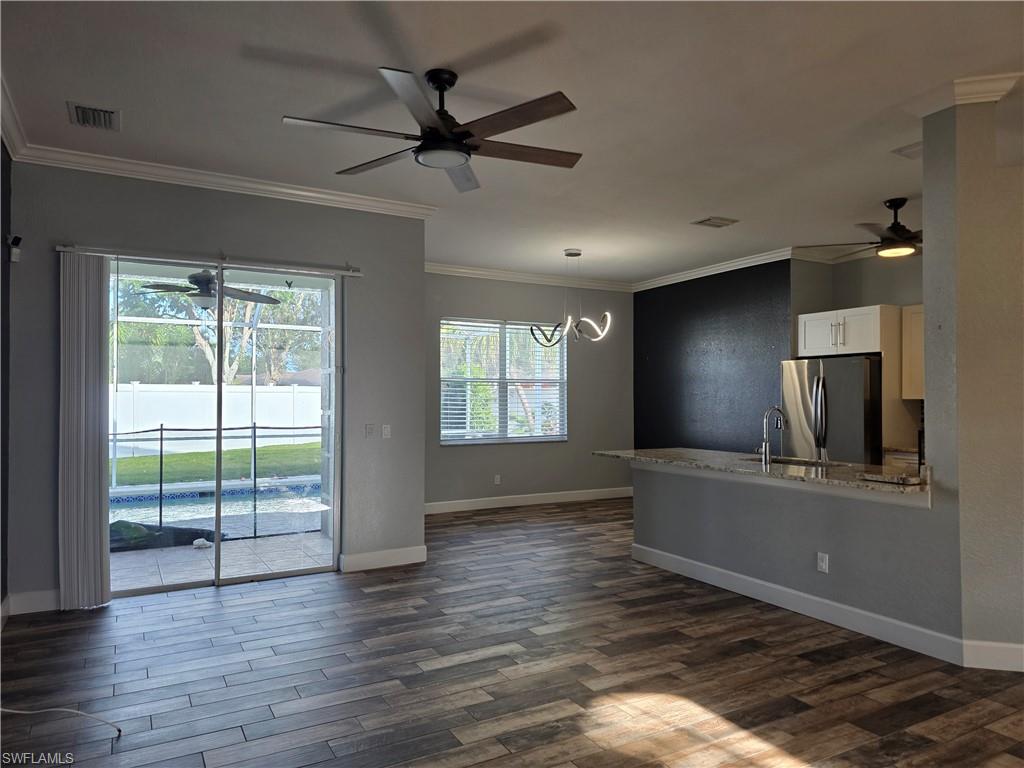 857 Summerfield Drive Naples, FL 34120 - Photo 48 of 50 an empty room with wooden floor fan and windows