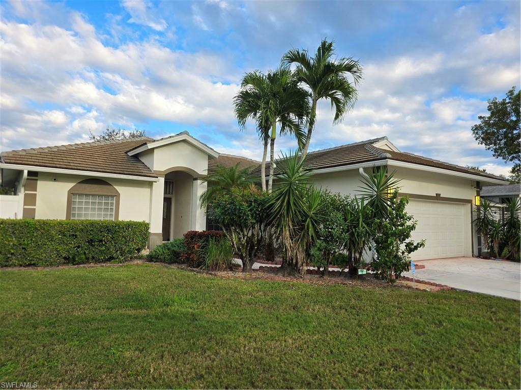 857 Summerfield Drive Naples, FL 34120 - Photo 7 of 50 a front view of house with yard and green space