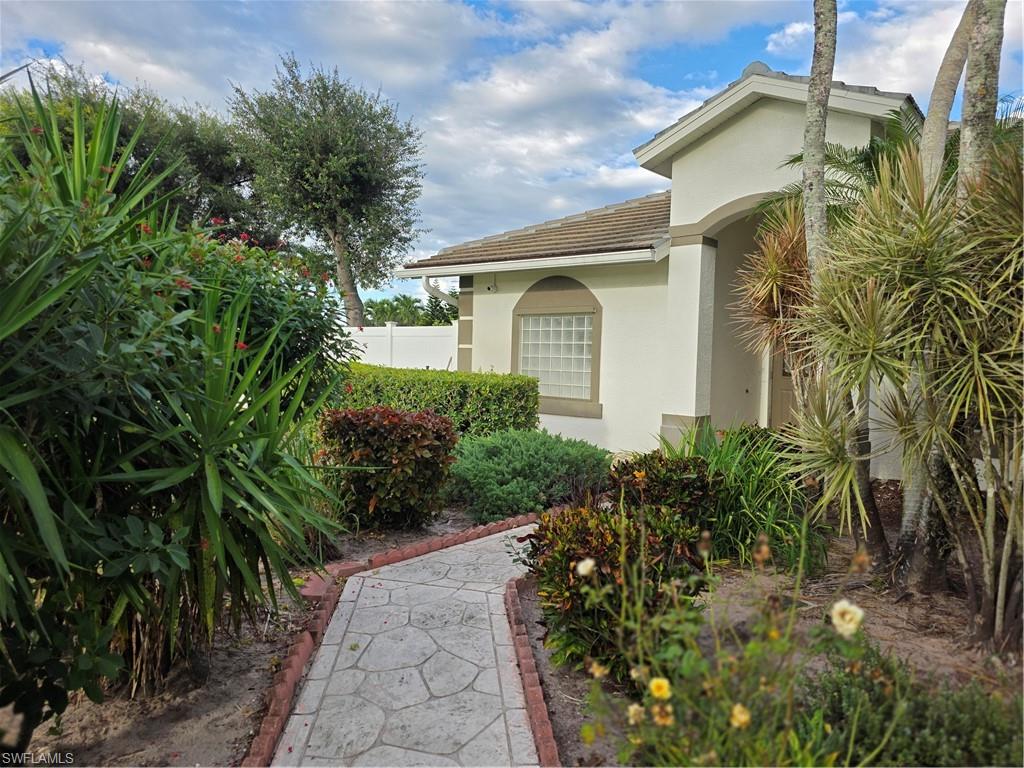 857 Summerfield Drive Naples, FL 34120 - Photo 10 of 50 a front view of a house with a yard