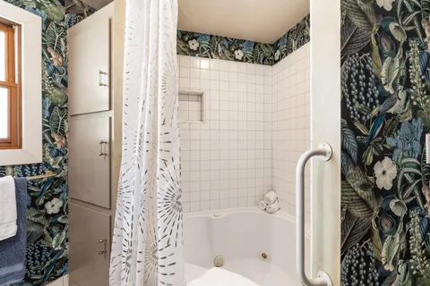 a bathroom with a sink a toilet and tub