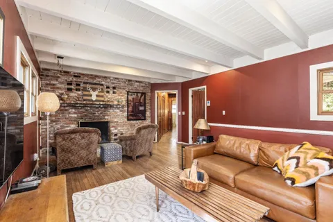 a bathroom with a tub a sink and a window