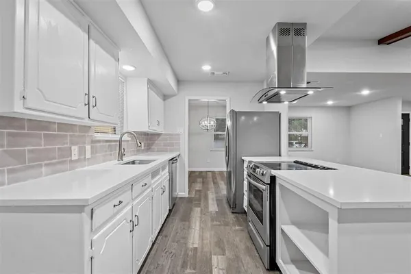a kitchen with stainless steel appliances granite countertop a sink stove and cabinets