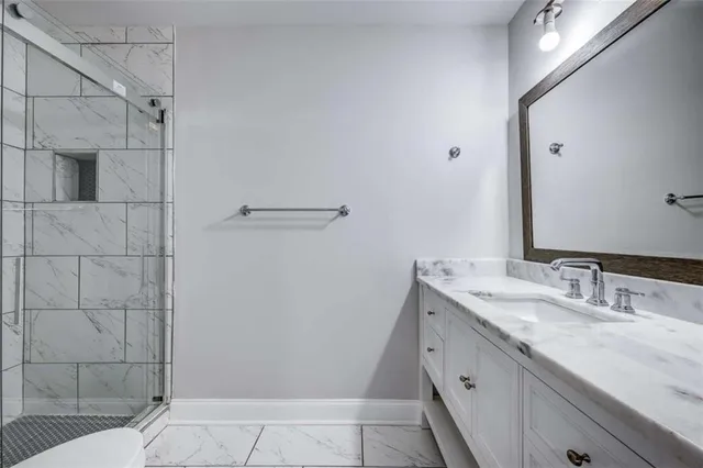 a bathroom with a granite countertop sink and mirror
