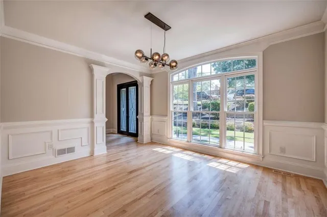 a view of a livingroom with wooden floor closet and windows