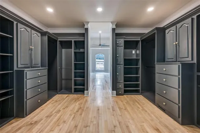 a view of walk in closet with clothes