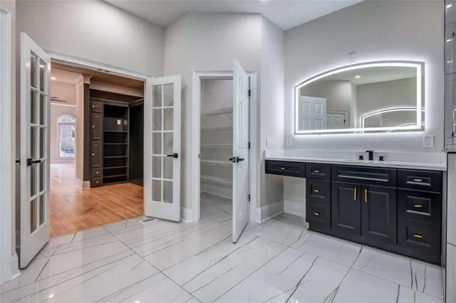 a bathroom with a sink vanity and mirror