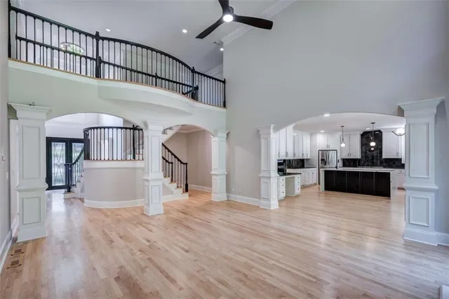 a view of living room kitchen and entryway with wooden floor