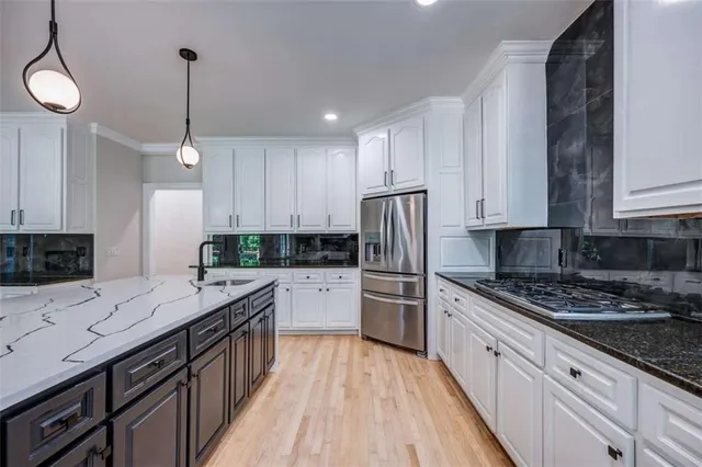 a kitchen with a refrigerator a sink and dishwasher