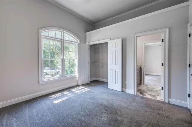 an empty room with windows and closet