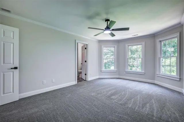a view of a livingroom with a ceiling fan and window