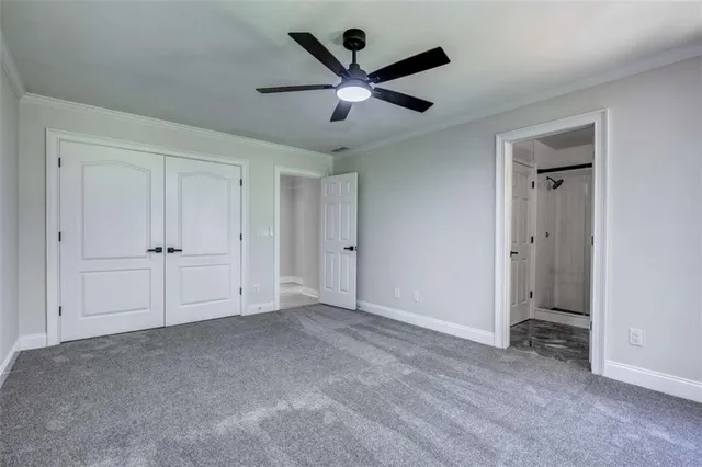 an empty room with closet and windows