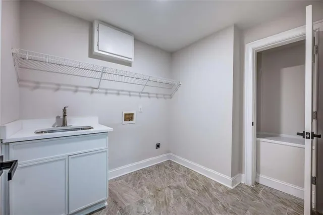 an empty room with windows and cabinet