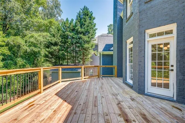 a view of balcony with wooden floor and fence